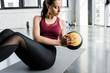 © LIGHTFIELD STUDIOS - focused fit sportswoman working out on abs with medicine ball at sports center