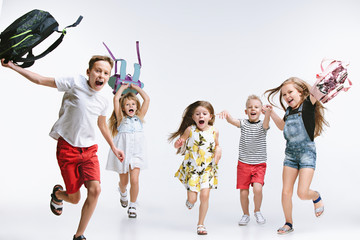 happiness group of cute and adorable teen children or students are back to school. over white studio