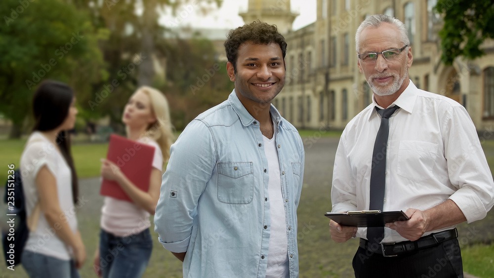 Senior teacher and student looking at camera, higher education opportunities