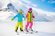 © famveldman - Ski and snow winter fun for kids. Children skiing.
