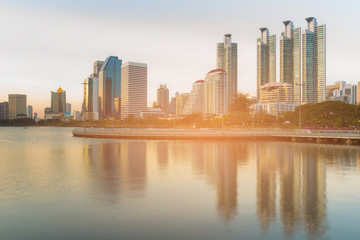 Wall Mural - Reflection over water lake City apartment in public park, Bangkok Thailand cityscape background