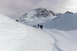 © serghi8 - Some snowshoe hikers walk through the snow-covered Alps in winter in the canton of Graubünden in Switzerland.