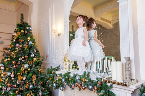 Little Girl Decorating Christmas Tree On Christmas Eve At