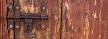 A Rusted Door Lock And Aldrop On A Brown Door