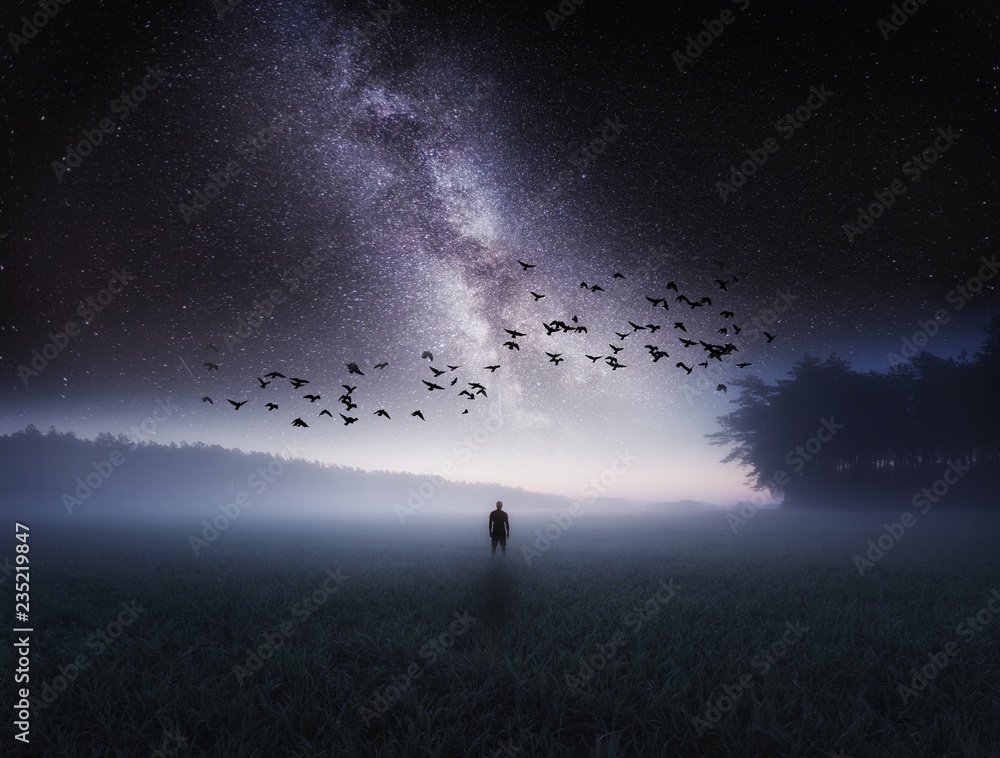 Dreamy surreal landscape with starry night sky and man silhouette - obrazy, fototapety, plakaty 