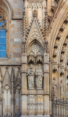 Wall Mural - Gothic detail of the sculptures on the facade and tracery of Cathedral of the Holy Cross and Saint Eulalia, or Barcelona Cathedral at sunset in Barcelona, Spain