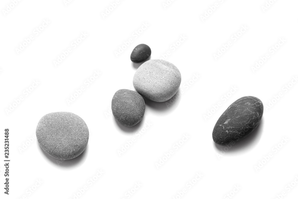 Scattered sea pebbles. Smooth gray and black stones isolated on white background. Top view - obrazy, fototapety, plakaty 