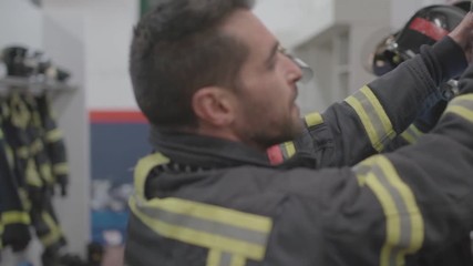 Wall Mural - Two firefighters prepare for the uniform to work.