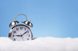 Alarm clock outdoors in snow