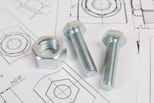 Technical Drawings Of Bolt And Nut. Engineering, Technology And Metalworking. Metal Bolt And Nut On Printed Drawings Background.