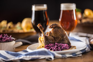 Wall Mural - Roasted christmas duck leg red cabbage dumplings liver draft beer and baked buns