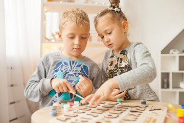 Preschoolers play and learn English letters using wooden alphabet.