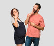 © luismolinero - Couple with pregnant woman yawning and covering mouth with hand. Sleepy expression on isolated grey background