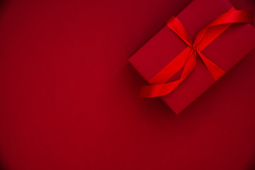 Wall Mural - red gift, present on red background top view. happy holidays greeting card.