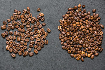 coffee grain (good and bad grain) - Arabica and Robusta blend (roasted coffee grain). Black background. Top view . Copy space.