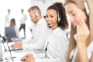 Wall Mural - Call center worker accompanied by her team.