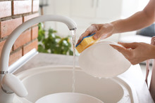 Woman Washing Dishes In Kitchen Sink, Closeup View. Cleaning Chores