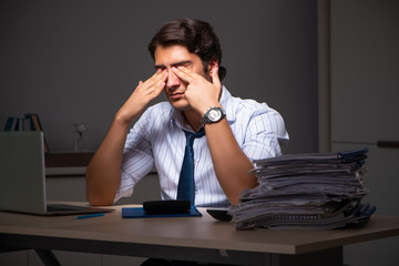 Young financial manager working late at night in office 