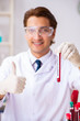 © Elnur - Young handsome lab assistant testing blood samples in hospital