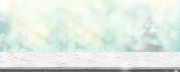 Leinwandbilder - Empty white marble table with abstract blur green christmas tree and snow fall background with bokeh light.Mock up banner for display of product.
