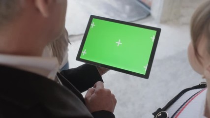 Sales agent holding ipad in new building. Man working as realtor in construction site with digital tablet monitor. Real estate broker showing green screen for internet website