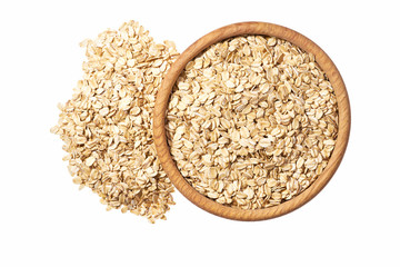 Oat flakes uncooked  in  wooden  bowl isolated on white background top view