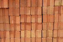 Red Bricks Are Stacked Wall /pile Of  Orange Bricks Baked Clay Background