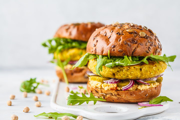 Wall Mural - Vegan chickpeas burgers with arugula, pickled cucumbers and hummus, copy space.