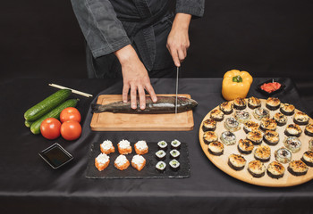 Wall Mural - ingredients for seafood dish.chef cutting vegetables and fish for breakfast. close up cropped photo