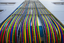 Different Bright Colors Electric Wires Installed On The Constructions Of Industrial Building.