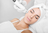 Fototapeta  - woman receiving no-needle high frequency mesotherapy at beauty salon. non-invasive procedure for skin rejuvenation