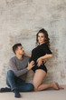 © Aleksandr - Happy man put his handr on the belly of his pregnant wife. Young family in studio. Couple wait for a baby