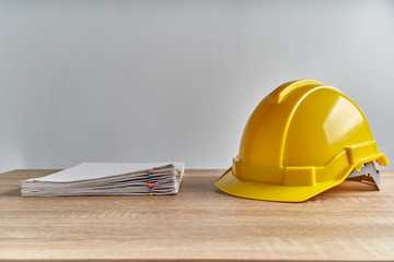 Wall Mural - Stack document report with yellow engineer hat on wooden table