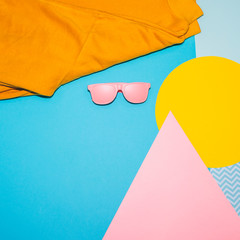 Wall Mural - Woman's fashion set of  pink sunglasses and yellow pullover on memphis style background. Geometry minimal concept. Fall and winter