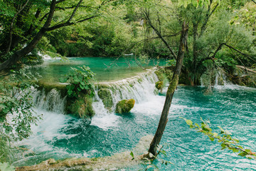 Travel to Croatia. Plitvice Lakes is a popular Croatian national park of incredible beauty. Photo of water cascades with emerald water