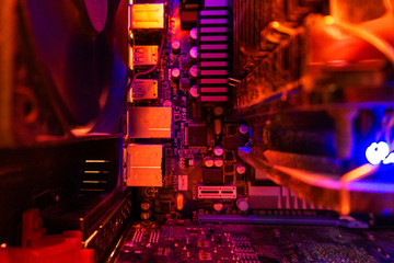 Inside a high performance computer. Computer circuit board and CPU cooling fans illuminated by internal LEDs inside a server class computer.