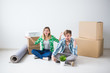 © satura_ - Relocation, new home and real estate concept - Young couple upacking in their new flat together