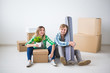 © satura_ - Relocation, new home and real estate concept - Young couple upacking in their new flat together