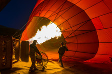 Silhouette Of A Man With Hot Air Balloons Night Time Inflating