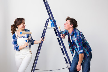 Teamwork, renovation and repair concept - Portrait of funny couple doing redecoration in apartment