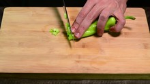 Cutting Banana Green Pepper With Knife On Wood