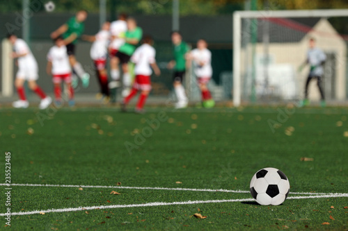 Fotografia Young boys playing a football match and empty space for text