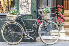 Vintage Bicycle With A Basket In Front And Behind, In Front Of A Store