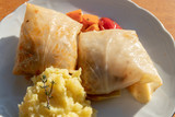 Fototapeta Tulipany - Handmade stuffed cabbage rolls with mashed potatoes. Traditional food in Germany.