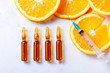 Vitamin C, natural anti aging cosmetics serum ampullas and syringe