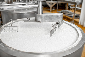 Milk mixing in the stainless tank during the fermentation process at the cheese manufacturing