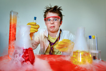 Crazy scientist. Young boy performing experiments