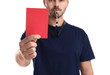 © New Africa - Football referee with whistle holding red card on white background, closeup