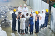 © Seventyfour - Full length portrait of two production managers meeting with factory workers in industrial workshop, copy space