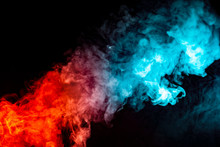 A Background Of Blue, Red And Green Wavy Smoke In The Shape Of A Ghost's Head Or A Man Of Mystical Appearance On A Black Isolated Ground. Bright Abstract Pattern Of Steam From Vape.
